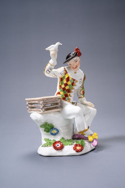 Meissen Harlequin figure with birdcage and bird